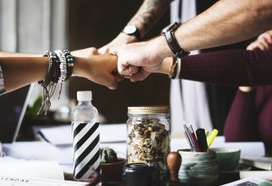 We are always there to lend a helping hand. People fist-bumping.