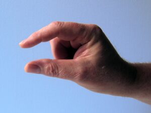 Hand showing a small sign, referring to a short-distance relocation.