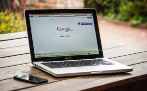 Google search bar on a laptop on a table.