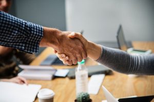 For our senior clients, no task is too difficult. Two people shaking hands.