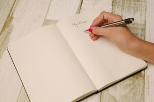 hand writing in a notebook a plan
