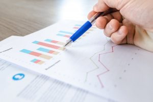Our piano movers NJ will gather all the facts about your relocation in due time. A close-up of a chart and a person holding a pen.