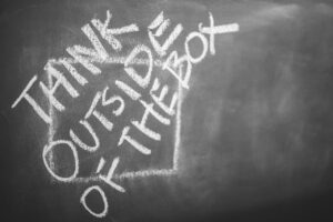 You need to be creative! think outside of the box written with chalk on a board