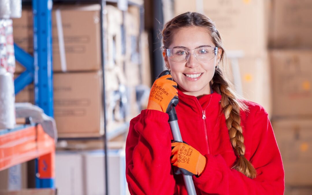 A woman in a red sweatshirt while cleaning, knowing the importance of keeping your storage clean.
