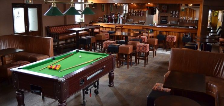 Moving a pool table is easy when you have the right manpower and equipment for the job. Pool table in a local pub.