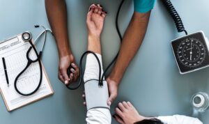 Not all employers offer health benefits. doctor checking blood pressure