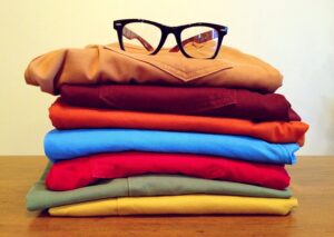 A pile of clothes with glasses on top