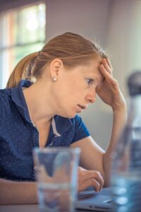 A woman under stress for preparing a moving budget