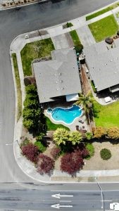 An aerial view of a suburb house with a swimming pool.