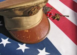 A military cap and an American fl