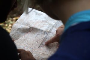 Two persons finding a home off-campus on a map.