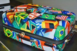Suitcases make excellent low-budget storage hacks A suitcase with flags.