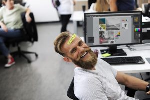 A happy man in an office.