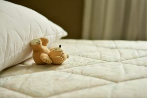 Sometimes, leaving behind your mattress is better than transporting it. Transporting a king-size mattress with a toy on it.