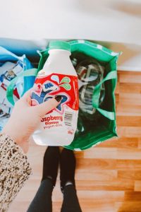 Recycle anything that you’ve used during your relocation that can be recycled. a person holding a plastic bottle