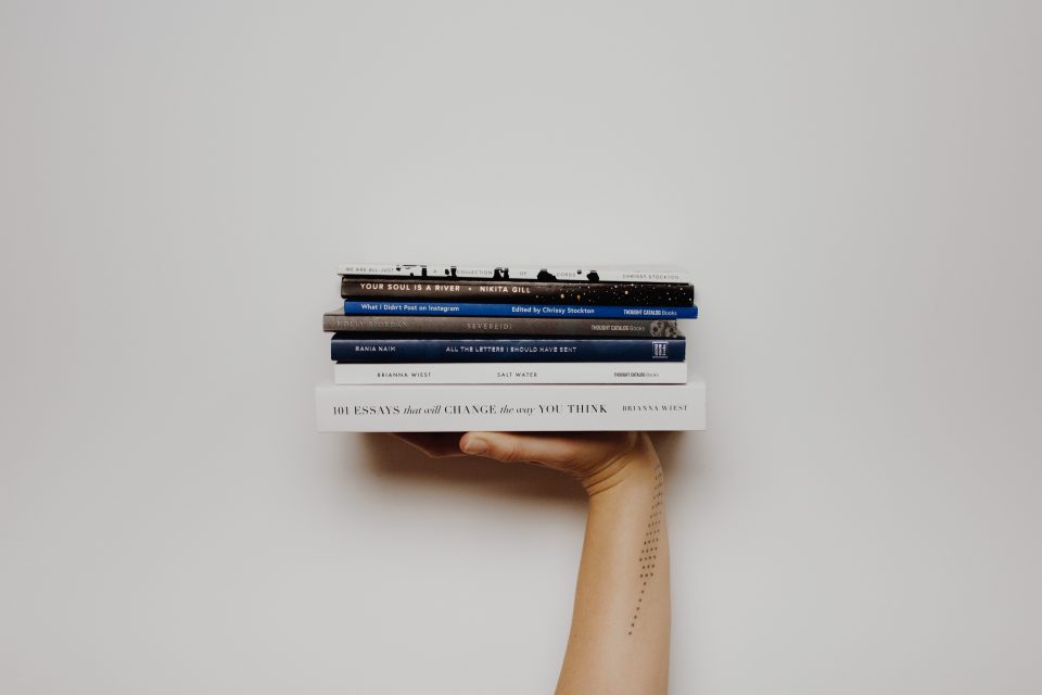 Image of books held on a palm