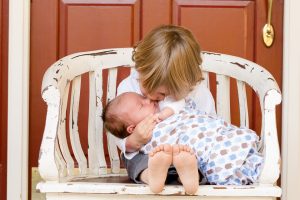 Two kids sitting on a bench.