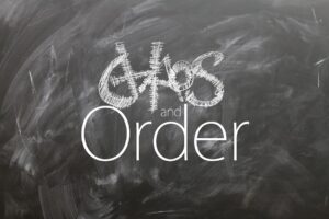 A blackboard with the words chaos and order written on it.