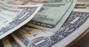 Be realistic when calculating your budget – the opposite won’t do you any good! Close up of dollar bills.