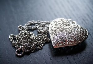 Plastic moving bins are great for storing valuables A heart shaped pendant