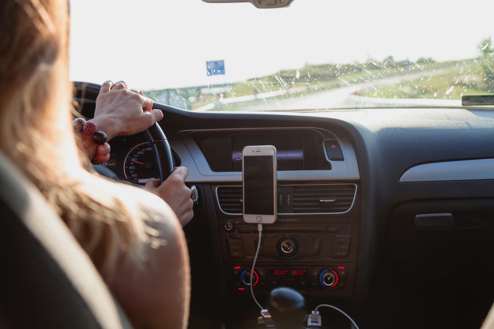 A woman driving a car alone.