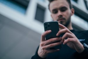 Choosing a moving provider is far easier in the internet era a man looking at his phone