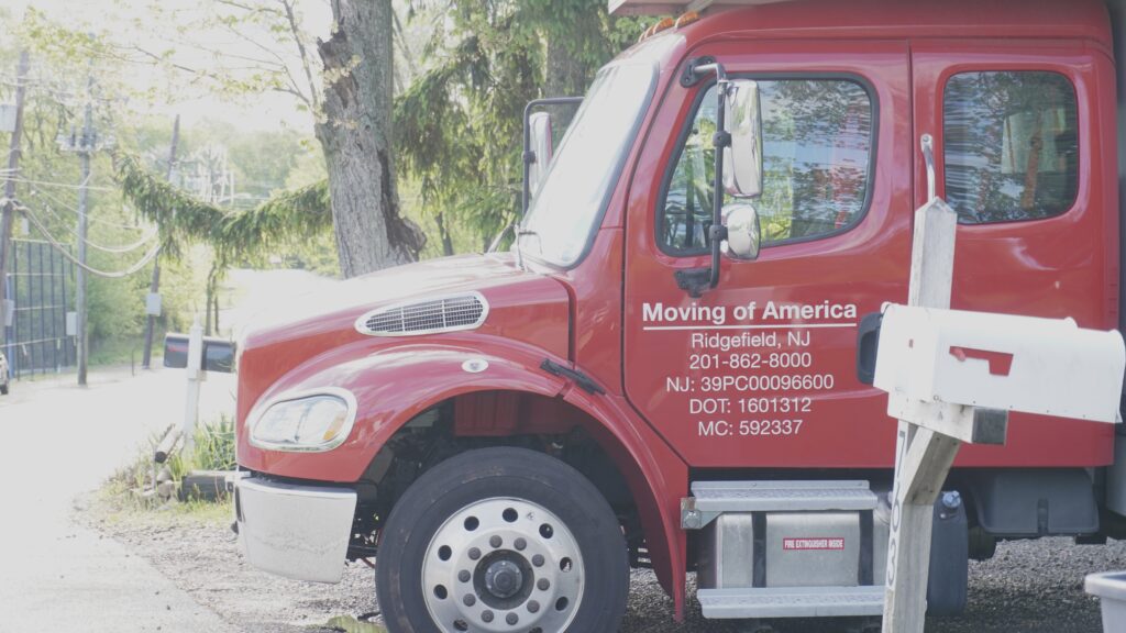 Red moving truck parked on street of Bergenfield