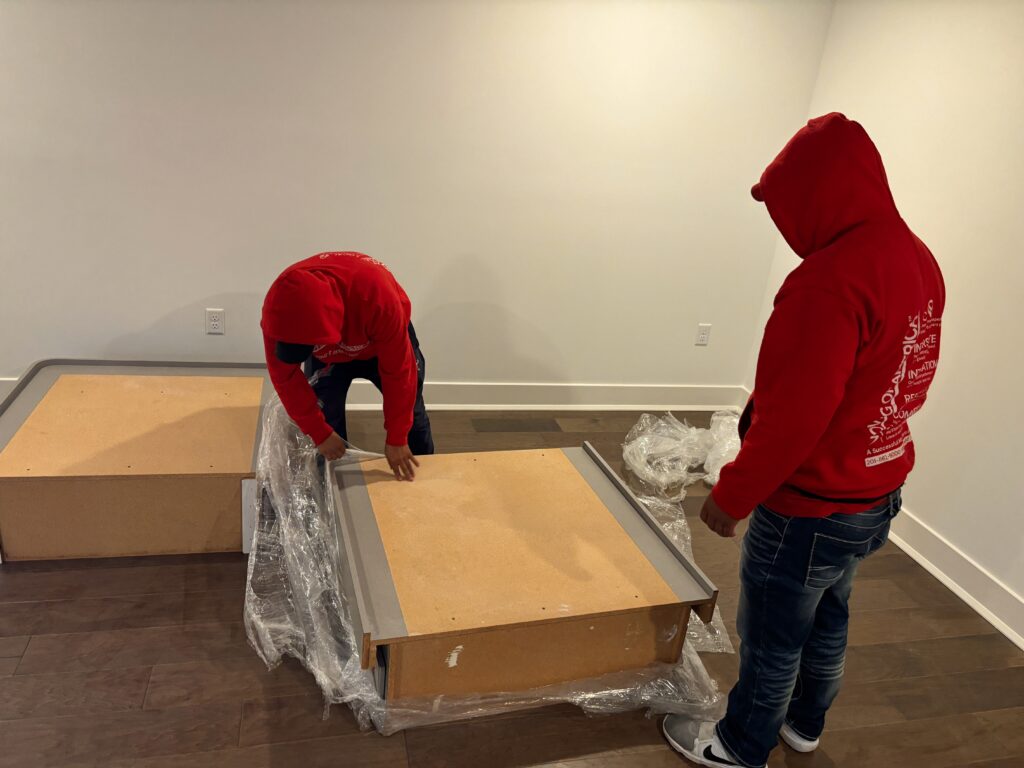 Moving of America specialists transporting a heavy-duty safe with professional equipment in New Jersey.